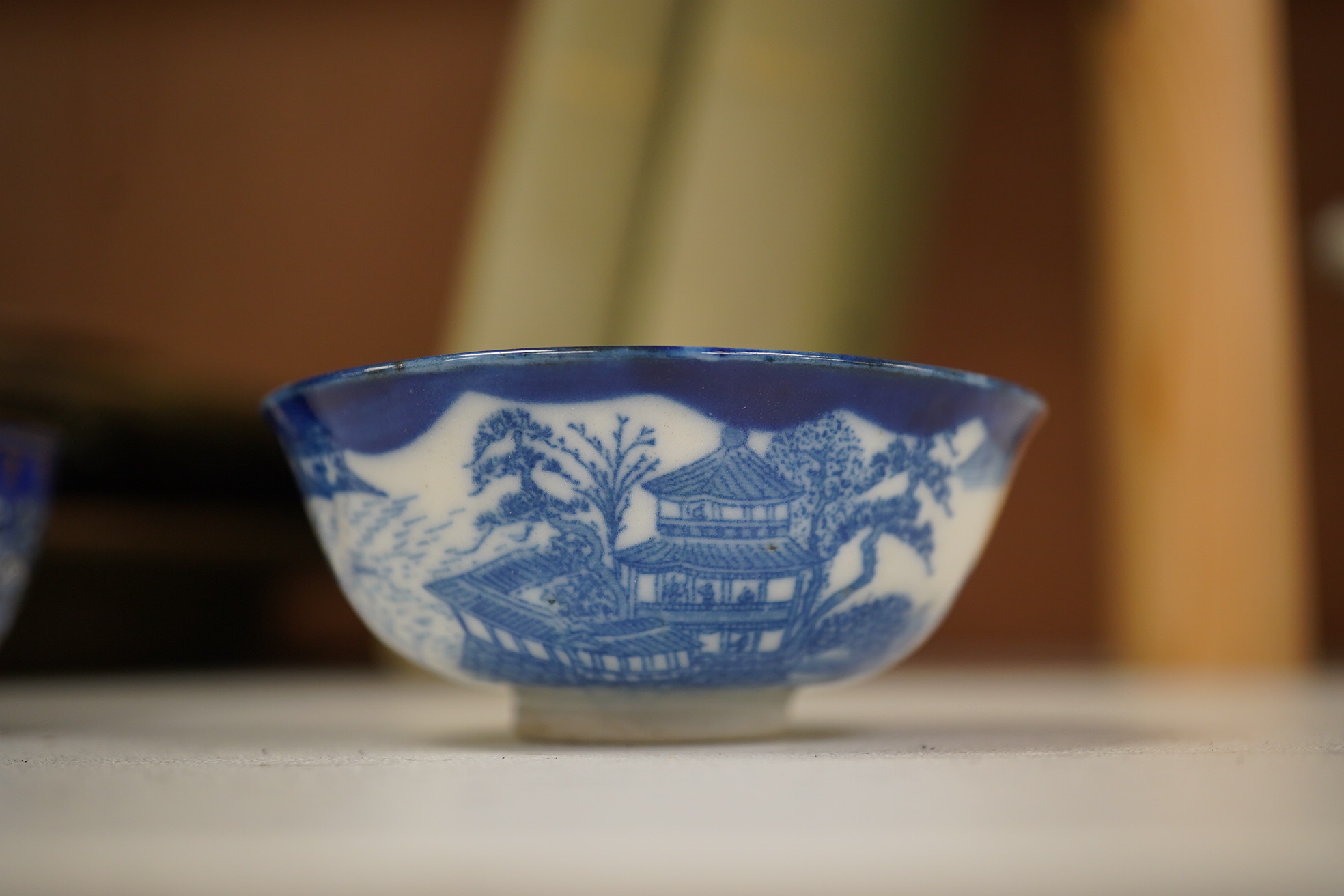 A group of Chinese blue and white porcelain, including a mid 19th century Canton enamel teabowl and a Japanese small dish, tallest 22cm. Condition - fair